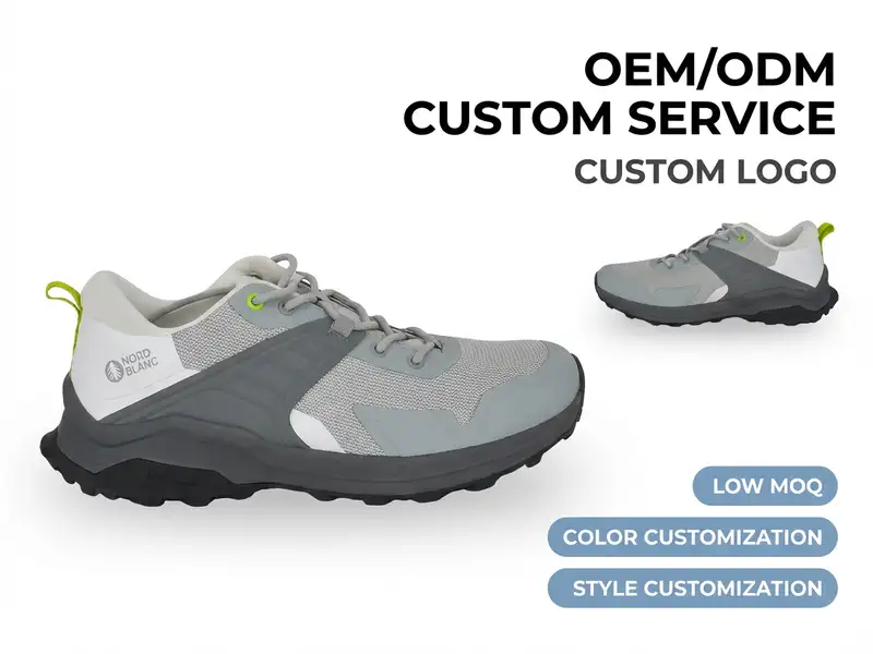 Footwear designer reviewing private label waterproof boot samples on a studio table surrounded by branding materials.